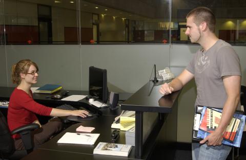 Student Speaks to Staff Person at Desk, AccessAbility Office