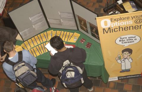 Students Look at Promotional Material at Michener Institute Booth, Graduate and Professional Schools Fair, the Meeting Place