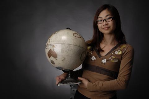 Student, Holding Desktop Globe, Promotional Image