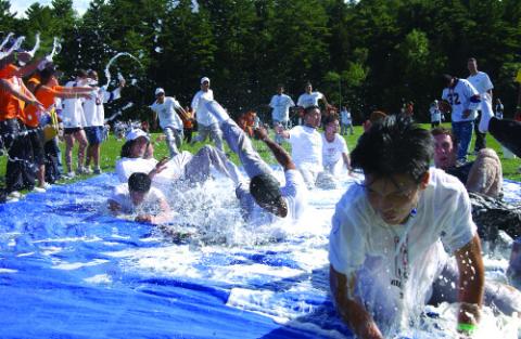 Students Play on Water Slide Mat, Event from Earlier Orientation