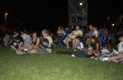 Students and Family Groups Sitting on Lawn at Summerfest, 2003