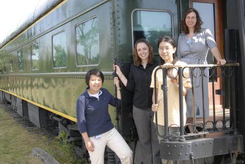 Three Co-op Students with Unidentified Woman, Posing on Railway Car, Arts Management Co-op Placement, Markham Museum
