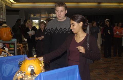 People Look at Pumpkin Carving Contest Entries, the Meeting Place