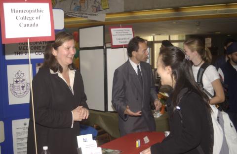 Students Speak with Representatives at Adjoining Tables, Homeopathic College of Canada and Occupational Therapy, Physical Therapy and Speech Language Pathology, University of Toronto, Graduate and Professional Schools Fair, the Meeting Place