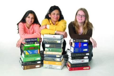 Students Posing with Stacks of Books, Newsletter Photograph