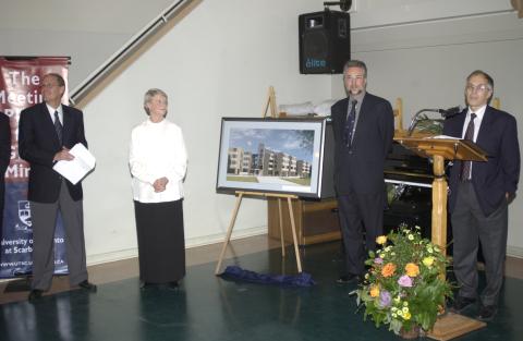 Joan Foley and Other Dignitaries Pose with Print of Joan Foley Hall, John Youson at Lectern, Joan Foley Hall Residence, Opening Event
