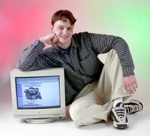 Student Posing with Computer Monitor, Promotional Photograph