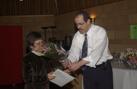 Robert Campbell Gives Flowers to Loan Le, Retirement Celebration for Pat Yakimov and Loan Le, Faculty Dining Room