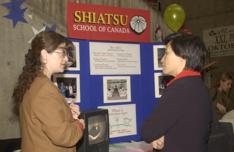 Student Speaks with Representative, Shiatsu School of Canada, Graduate and Professional Schools Fair, the Meeting Place