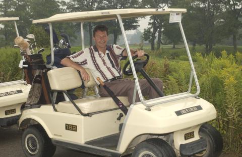 John McKay in Golf Cart, Management Alumni Association Golf Tournament, 2002, Deer Creek Golf Club