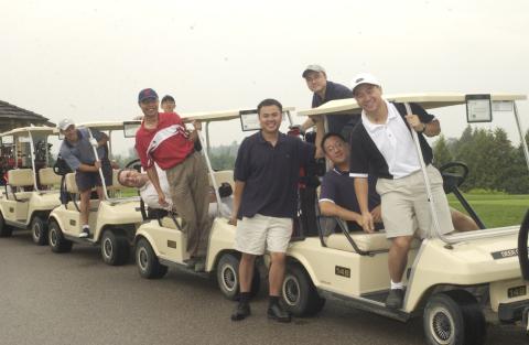 Row of Golf Carts with Players Posing for Photograph, Management Alumni Association Golf Tournament, 2002, Deer Creek Golf Club