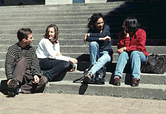 Four People seated on H-Wing Patio Steps