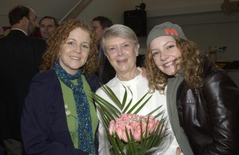 Joan Foley, Holding Flowers, with Two Attendees, Joan Foley Hall Residence, Opening Event
