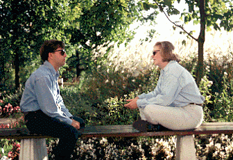 Two Students Seated on Bench, H-Wing Patio