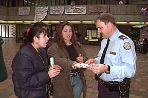 Three Students Speaking with Campus Police Officer, the Meeting Place