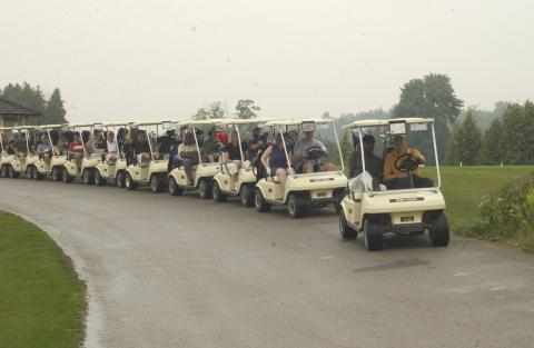 Row of Golf Carts being Driven, Management Alumni Association Golf Tournament, 2002, Deer Creek Golf Club
