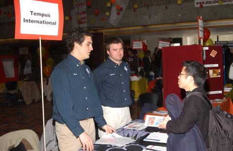 Student Speaks with Presenter at Tempus International Table, Volunteer Fair, the Meeting Place