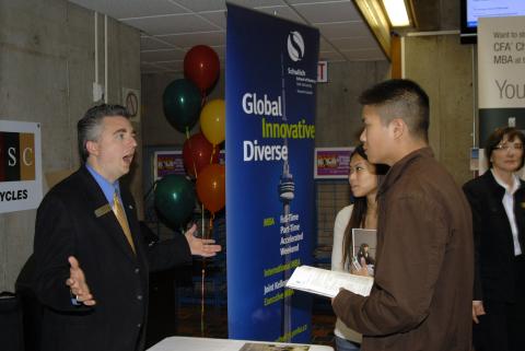 Student Speaks with Representative, Graduate and Professional School Fair, the Meeting Place
