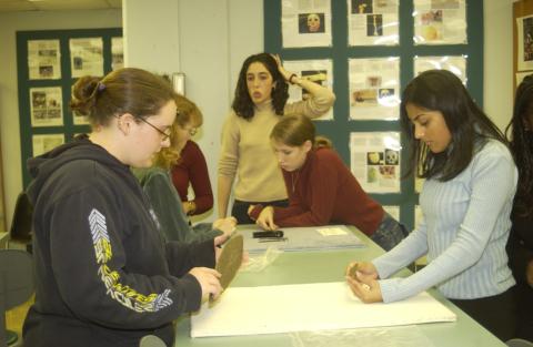 Anthropology Class Looks at Artifacts on Table
