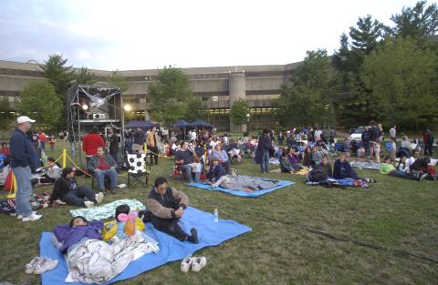Summerfest, Audience Assembling on Lawn for Night-Time Film Screening, (Image shows Projector Tower)