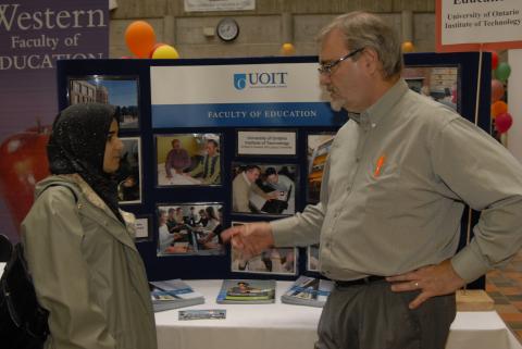 Student Speaks with Presenter, Faculty of Education, University of Ontario Institute of Technology (UOIT), Graduate and Professional Schools Fair, 2006, the Meeting Place