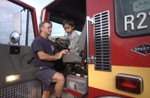 Summerfest, Child tours Fire Truck with Member of Toronto Fire Service