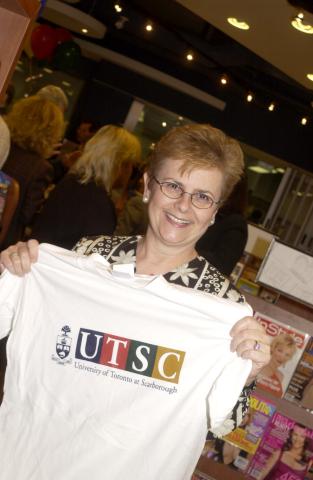 Woman Poses for Photograph with University of Toronto Branded Merchandise, Opening Reception, UTSC Bookstore, Bladen Wing and Academic Resource Centre