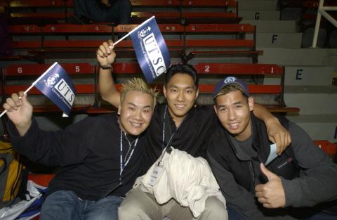 Three Students with Pennants, Hockey Game, Homecoming Event (Varsity Arena, St. George Campus?)