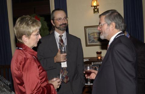 Tom Enright and Unidentified Attendee Speak with Paul Thompson at Advancement Christmas Party, Miller Lash House