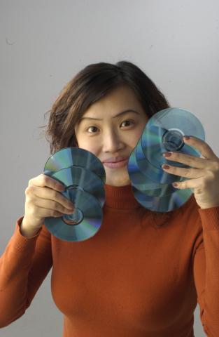 Wynne Leung, New Media Studies, Co-op Student, Holding DVDs, Promotional Photograph