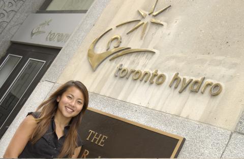 Co-op Student Outside Toronto Hydro Building, Management and Economics Co-op Placement, Toronto Hydro, Promotional Image