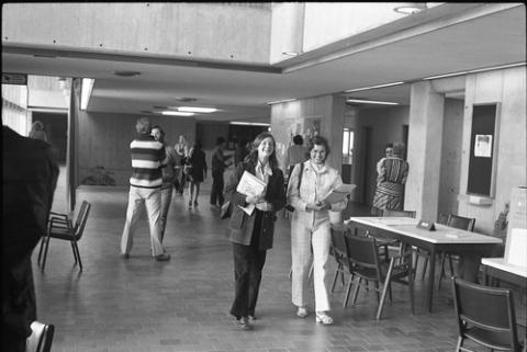 Two Students Walking Down Hall