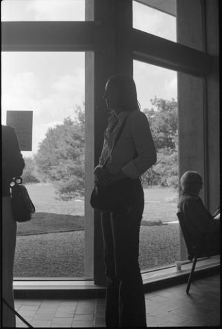 A Student Standing by a Window