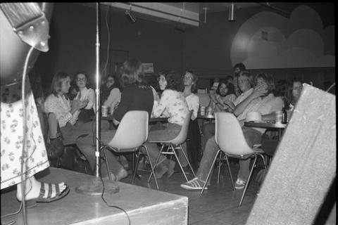 Band Onstage While Seated Students Watch in College Pub
