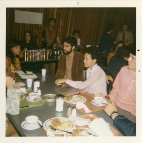 Students Seated at Table with Food by Bar