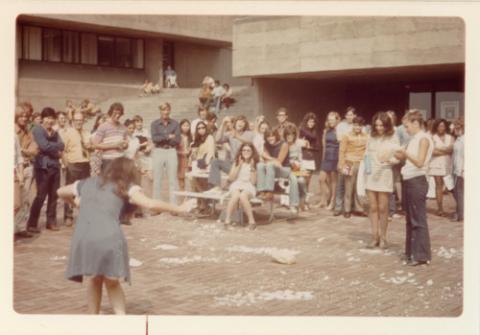 Crowd of Student Standing on Patio Behind Humanities Wing