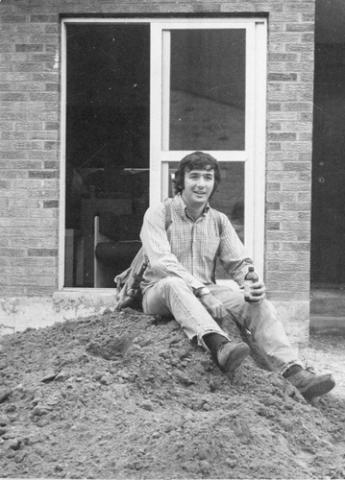 Student Sitting on Pile of Dirt