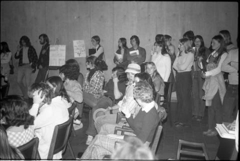 Students Standing and Sitting in Audience