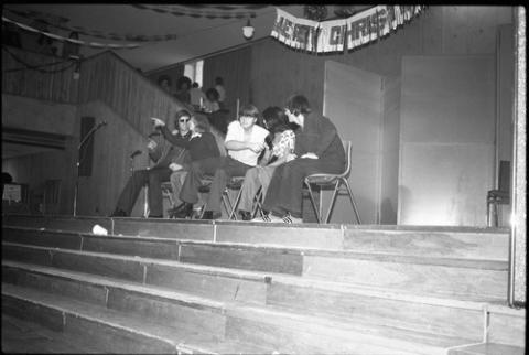 Five Students Sitting Onstage