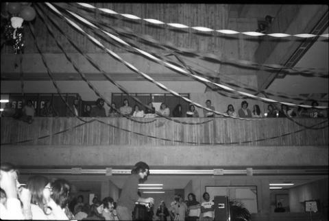Students Seated on Ground Floor and Standing on Balconys