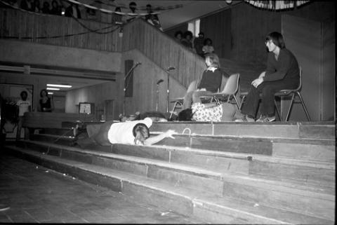 Two Student Sitting Onstage whiel 3 Lay on the Stage and Steps