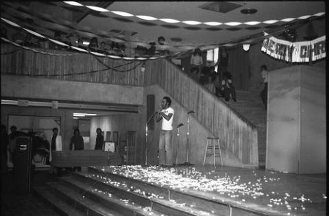 Student Standing Onstage with Confetti