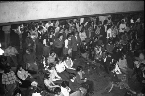 Students Standing and Sitting in Audience in The Meeting Place
