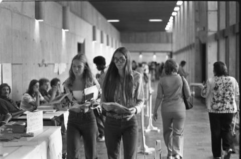 Students Walking Past Registration Tables