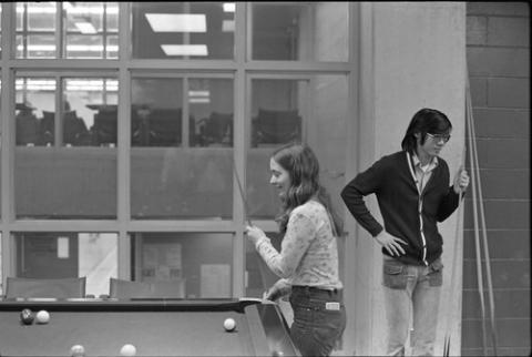 Students Standing with Pool Cues