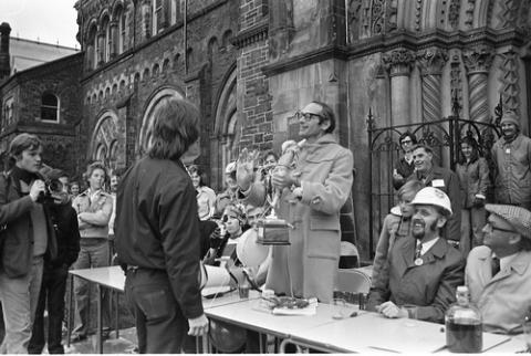 Official Presenting Trophy to Student in Front of University College