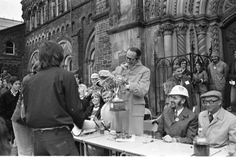 Student Being Presented Trophy in Front of University College