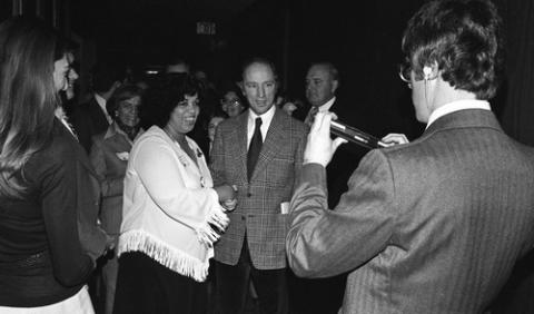 Person Taking Photograph of Pierre Trudeau and Attendee