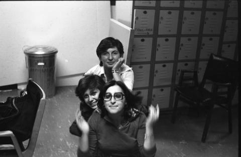 Three Students Psoing in a Room with Lockers