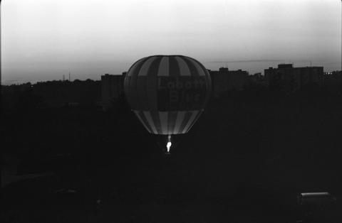 Hot Air Balloon Rising Above Field